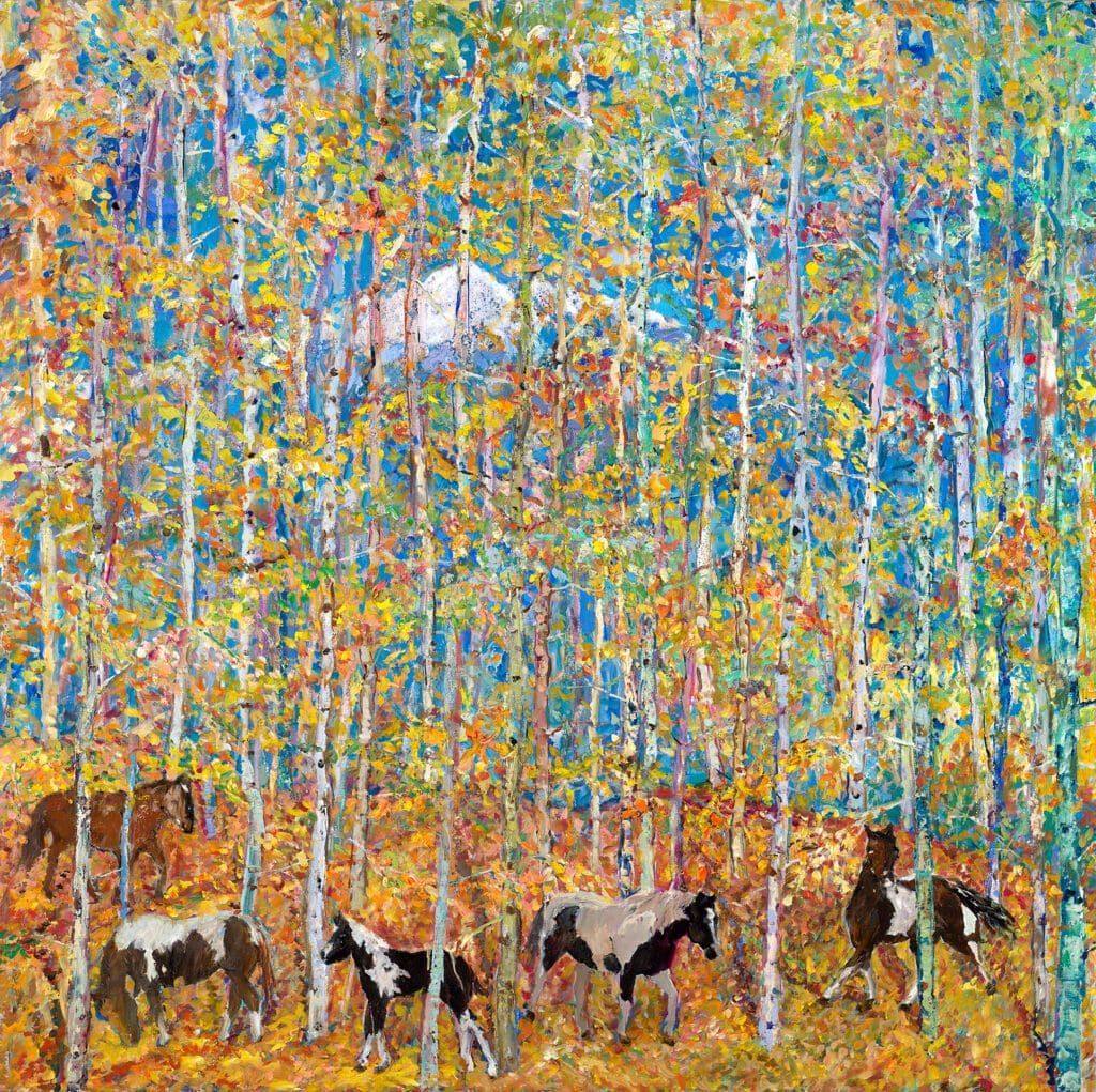 Horses graze in a colorful autumn forest.