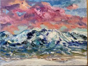 Pink sky over snow-capped mountains.