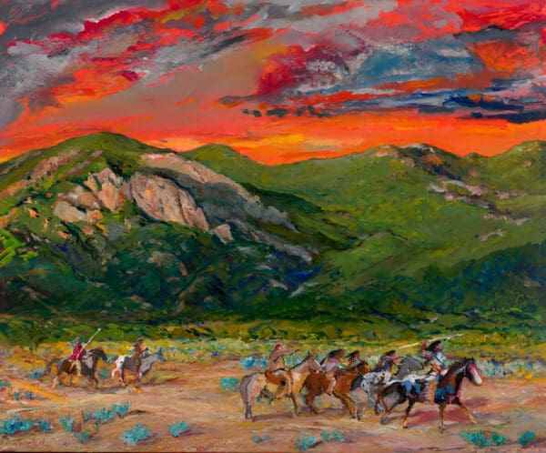 Native American riders at sunset in mountains.