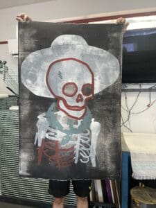 Skeleton wearing a cowboy hat and bandana.