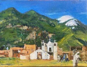 Mountain village with white church.